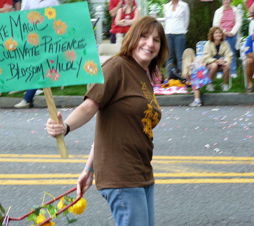 robin with sign walking in parade